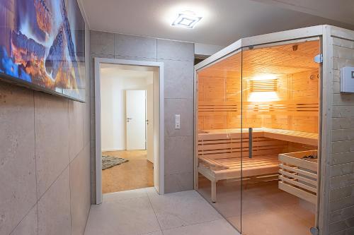 a room with a walk in closet with a glass door at Landhaus Biewald in Göttingen