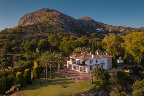 an aerial view of a house with a mountain in the background at Cubo's Mountain Bayview Luxury Villa in Málaga