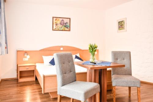 een eetkamer met een tafel en 2 stoelen bij Hotel Panorama in Elbigenalp