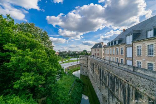 a bridge over a river in front of buildings at Cerise Nantes Atlantis in Saint-Herblain