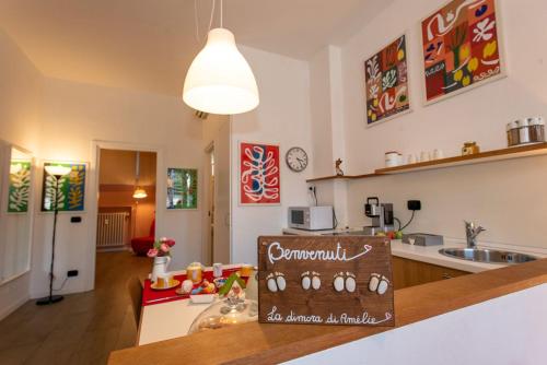 a kitchen with a counter with a sign on it at La dimora di Amélie-Self Check in-Parcheggio gratuito in San Lazzaro di Savena