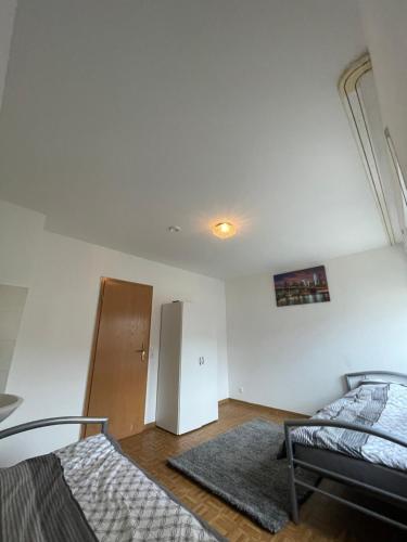 a living room with two beds and a refrigerator at 1 Zimmer für 2 Personen Bruchsal ruhige Lage (Monteurzimmer) in Bruchsal