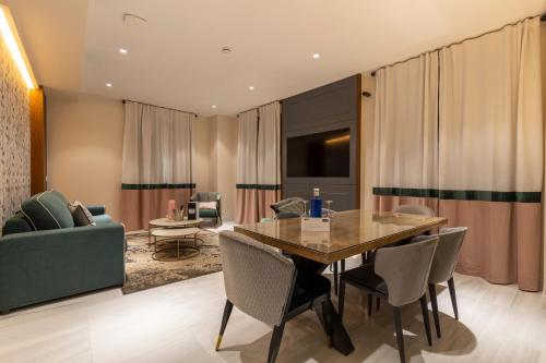 a dining room with a table and a couch at BiBo Suites Real Chancilleria in Granada