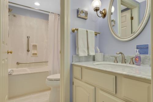 a bathroom with a sink and a toilet and a mirror at 212 Water Street Inn in Boyne City