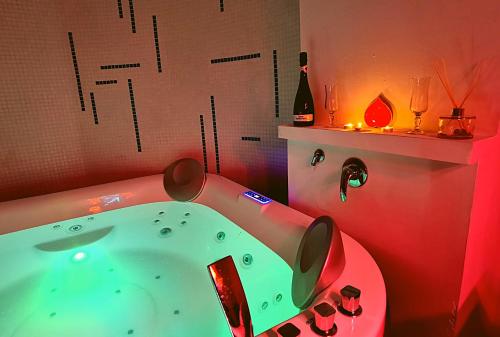a bathroom with a green tub in a red room at Saracen Sands Hotel & Congress Centre - Palermo in Isola delle Femmine