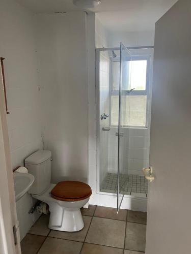 a bathroom with a toilet and a glass shower at Mzingazi waterfront in Richards Bay