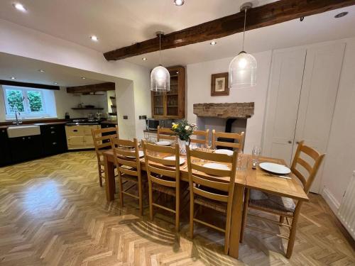 a kitchen and dining room with a table and chairs at Stunning 4 bed Grade house in the Lake District in Wigton