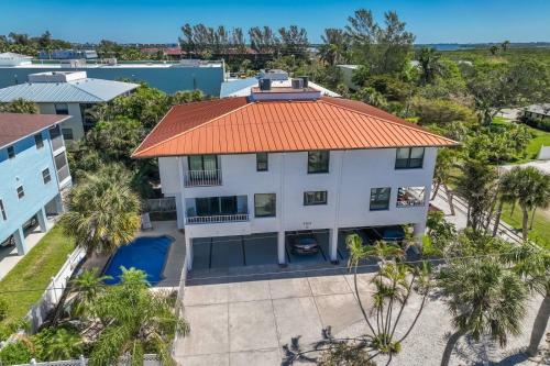 an aerial view of a white house with an orange roof at Hidden Pearl home in Holmes Beach