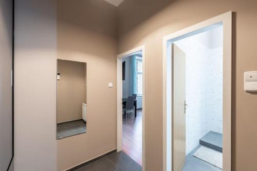 a hallway with a door leading into a room at Vals Garden Apartment in Prague
