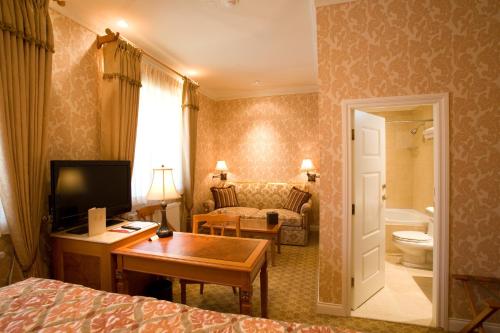 a hotel room with a bed and a desk and a bathroom at Terelj Hotel & Spa in Ulaanbaatar