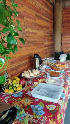 a table with a table cloth with food on it at Pousada Maia in Itaúnas