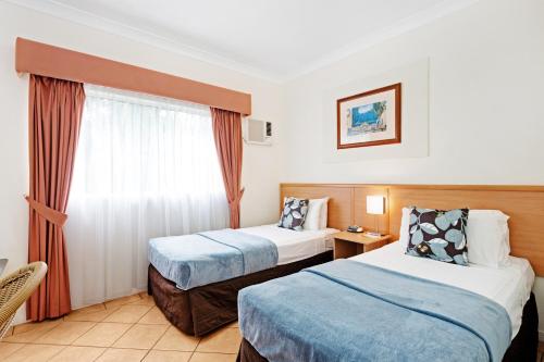 Ένα ή περισσότερα κρεβάτια σε δωμάτιο στο Cairns Queens Court