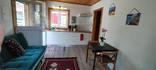 a living room with a couch and a table and a kitchen at Sintra Serenity in Sintra