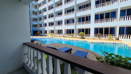 una piscina di fronte a un edificio di c3 Cowrie Shell Residences a Mombasa