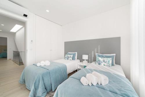 a bedroom with two beds with towels on them at Villa Atlântico - By SCH in Salir do Porto