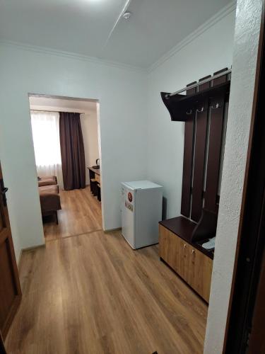 an empty room with a living room with a couch and a room with at КП ДР Готель in Drogobych