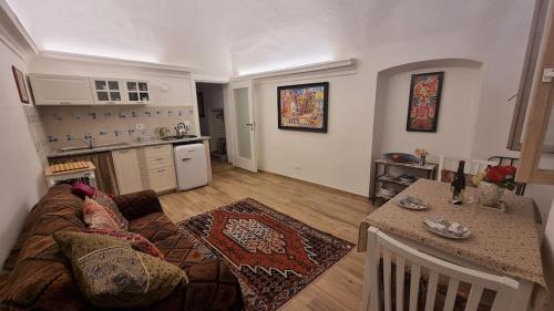 a living room with a couch and a table at Beautifully restored romantic apartment in the centre of historic Dolcedo in Dolcedo