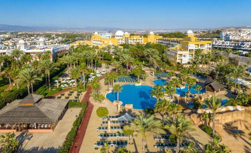 an aerial view of a resort with a pool and palm trees at Playazimbali in Vera