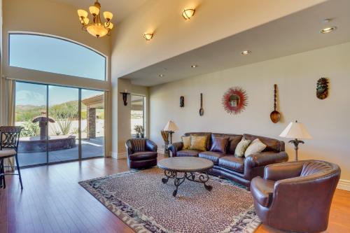 a living room with a couch and a table at Hot Tub, Yard and Views Spacious Cave Creek Home in Cave Creek