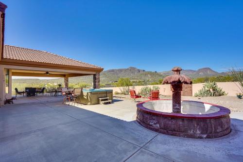 a patio with a fountain in front of a house at Hot Tub, Yard and Views Spacious Cave Creek Home in Cave Creek