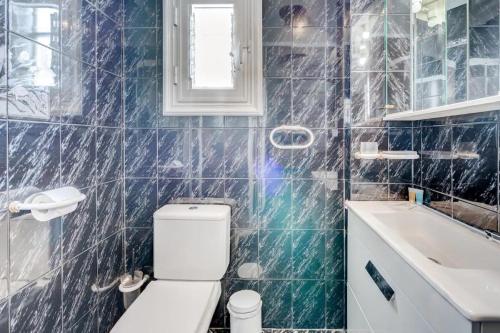 a bathroom with a white toilet and a sink at Los Gigantes Sea View in Santiago del Teide