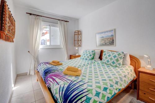 a bedroom with a bed with two towels on it at Los Gigantes Sea View in Santiago del Teide