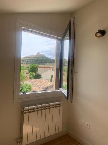 a window in a room with a radiator and a view at La Rinconada in Castrojeriz