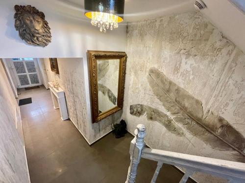 ein Badezimmer mit einem Spiegel und einer Marmorwand in der Unterkunft Pod Lwem in Kościerzyna