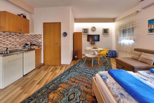a living room with a bed and a kitchen at Villa Acapulco in Mostar