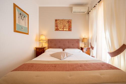 a bedroom with a large bed and a window at Affittacamere Valentina in Orvieto