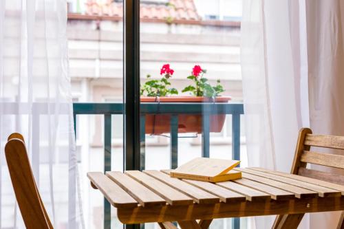 a table with a book and a potted plant on it at Casa Naseiro in Melide