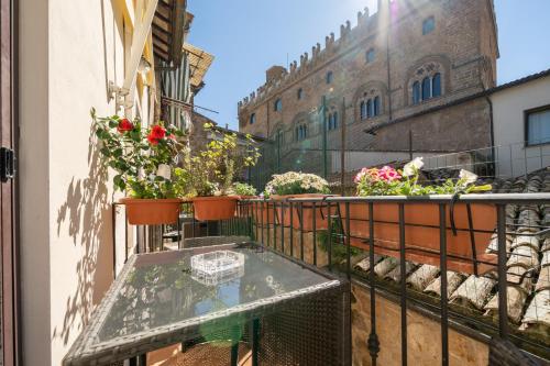 a balcony with potted plants on a building at Affittacamere Valentina in Orvieto