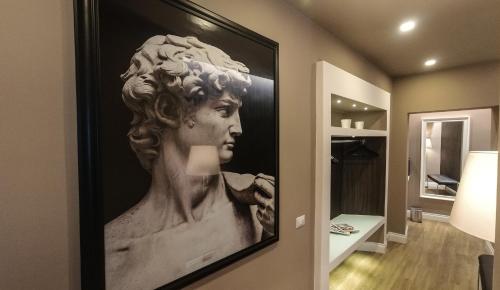 a painting of a bust of a man on a wall at Il Borgo Luxury Suites in Nettuno