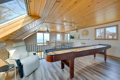 a large room with a pool table and a chair at Amazing Rocky Point Retreat Overlooking the Sound! in Rocky Point