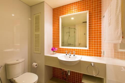 a bathroom with a sink and a toilet and a mirror at Mykonos Condo in Hua Hin