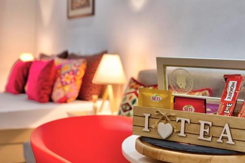 a living room with a couch and a table with a red chair at Villa Acapulco in Mostar