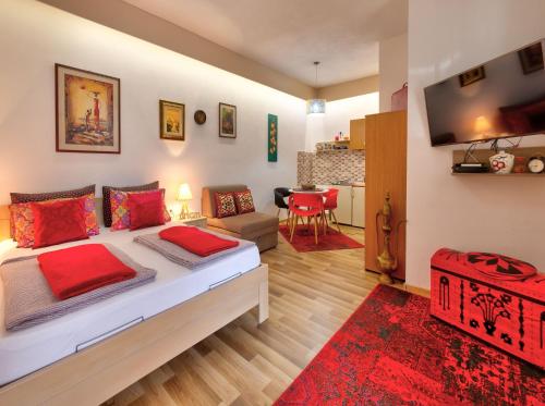 a bedroom with a bed and a living room at Villa Acapulco in Mostar
