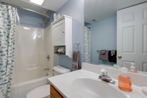 a bathroom with a white sink and a toilet at Manistee Retreat with Pool Access, Walk to Beach! in Manistee