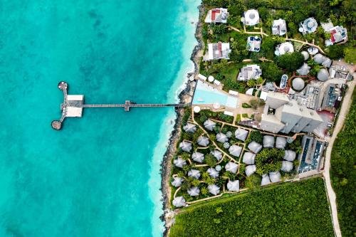an aerial view of an island with houses and the water at Essque Zalu Zanzibar in Nungwi