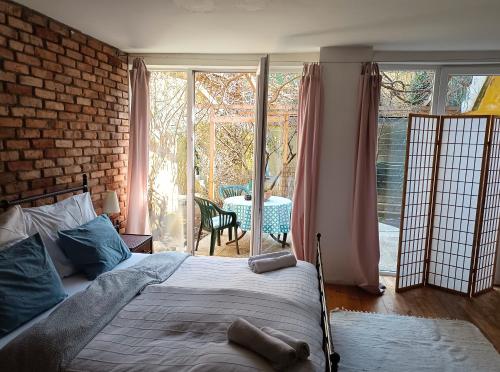a bedroom with a bed and a brick wall at Boho-Style-Apartment in Sankt Veit an der Glan