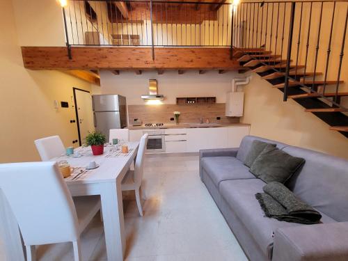 a living room with a couch and a table at Borgo Antico Lake Endine Hospitality in Endine Gaiano