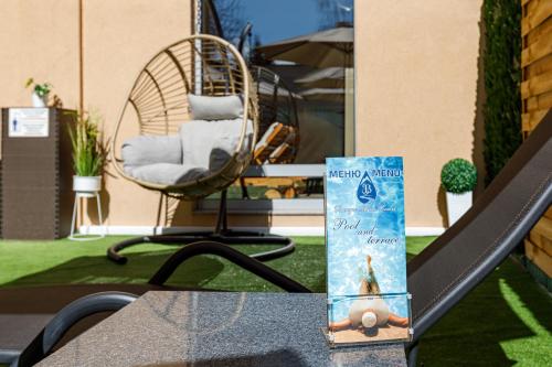 a book sitting on a table with a chair at Баня Аква Ризорт in Banya