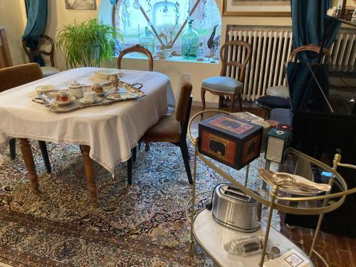 a room with a table with plates of food on it at Chambres d'hôtes Le Relais de la Perle in Le Vernois