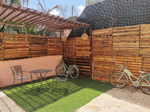 a patio with two bikes parked next to a fence at Hotel Casa Henequén in Valladolid