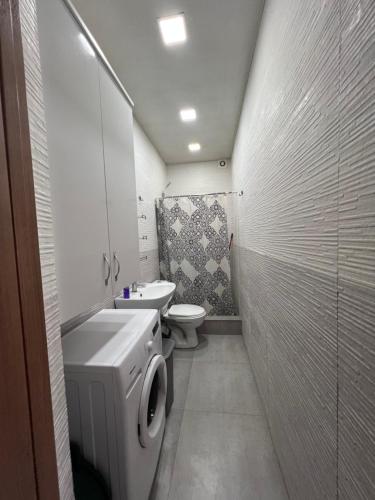 a small bathroom with a toilet and a sink at Amazing flat in the best location in Tskaltubo