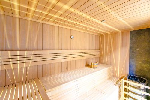 a sauna with a bench in the middle of it at Resort Hevenia Rewal 7 in Rewal