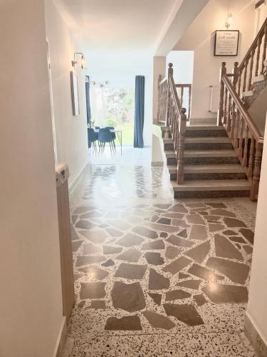 a hallway with a stone floor and stairs at Villa Vincentów in Myślenice