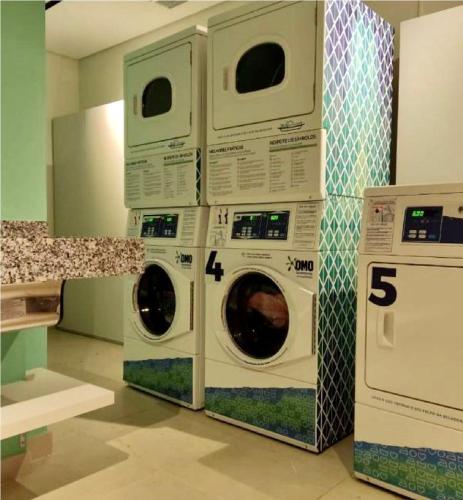 two washing machines stacked on top of each other at MV 148B Fantástico Apartamento Em Frente Ao Metrô Brás ! - Rua Coronel Mursa, 56 - Bras in Sao Paulo