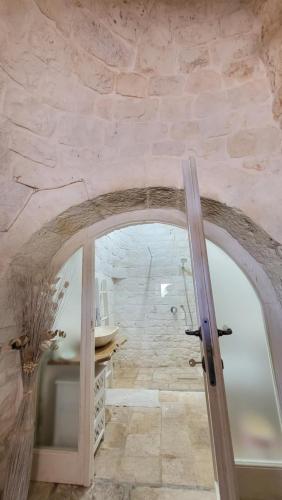 a bathroom with a shower and a glass door at Casa Relax Isabelle in Alberobello