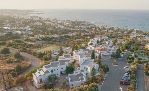 an aerial view of a town with the ocean at Sunshine Village Hotel in Hersonissos